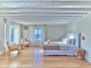 a bedroom with a large bed in a white room at Villa Maera 3 in Kalo Livadi +56 photos