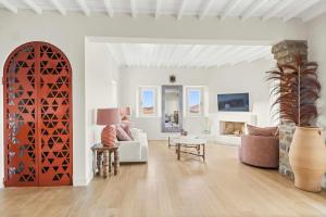 a living room with a couch and a table at Villa Maera 3 in Kalo Livadi