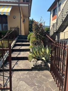 a set of stairs leading to a house with a fence at Appartamento Le lame in Corte Franca