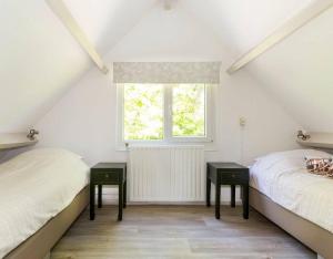 Ένα ή περισσότερα κρεβάτια σε δωμάτιο στο Bungalow Jonkerstee 207