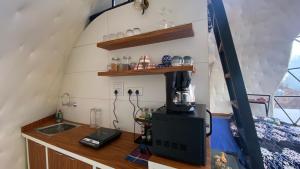 a kitchen in a tiny house with a sink at We Are Made Of Stories in Joshīmath +24 photos