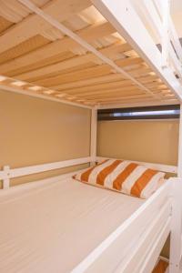 a loft bed in a room with a window at Ilot de paix in Ostend +17 photos