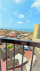 a view from a balcony of a city and the ocean at Apezinho da Soltony em Peruibe in Peruíbe +11 photos