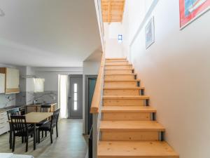 a staircase in a room with a table and chairs at Dea's home in Himare