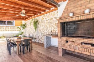 a dining room with a brick fireplace and a table at Casa Costa Molina, en el corazón del Atlántico in Puntallana