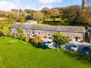 an aerial view of a stone house with parked cars at Turtle Cottage in Charlestown