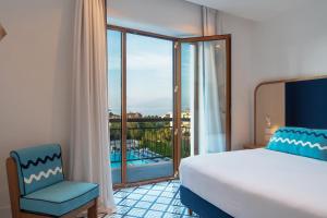Кровать или кровати в номере Grand Hotel Flora
