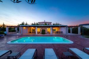 a swimming pool in a backyard with a house at Villa Almond in Nin