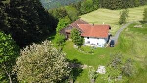 an aerial view of a house in a field at Ferienhaus Ramersdorf in Kollnburg +7 photos