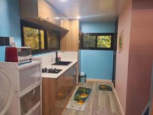 a small kitchen with a sink and a stove at Entire Loft House Patio & Garden, Belle's Homestay in Balanga
