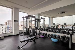 a gym with a bunch of machines in a room at Chic Centric 1BR Apt, King Bed in Los Prados