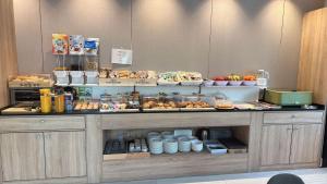 a bakery counter with pastries and other food items at Hotel Golden Alcorcon in Alcorcón