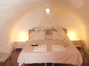 Postel nebo postele na pokoji v ubytování Trulli e Masseria Ianella