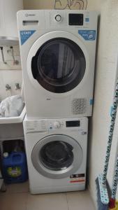 a washing machine is sitting next to a washer at Ap Skerup Calpe City cerca Playa in Calpe