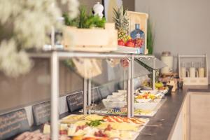 a buffet line with many different types of food at Garner Hotel Augsburg Nord by IHG in Augsburg
