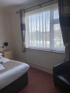 Postel nebo postele na pokoji v ubytování Merlewood Hotel