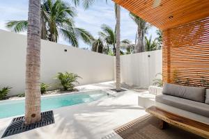 a backyard with a swimming pool and palm trees at Punta Mágica Villas Privadas in Brisas de Zicatela