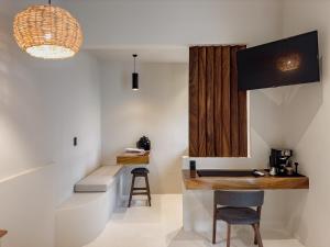 a kitchen with a counter and a stool in a room at Punta Mágica Villas Privadas in Brisas de Zicatela