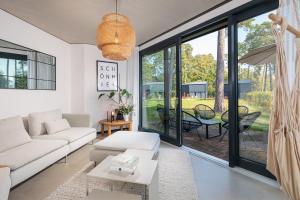 a living room with a couch and a table at Haus 1 - ELF AM SEE in Templin