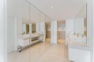 a white bathroom with two sinks and mirrors at SVB Aquasuites Luxury Penthouse - A02 in Santiago del Teide +18 photos
