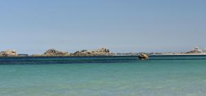 an elephant in the water with rocks in the background at Ty Koant in Cléder