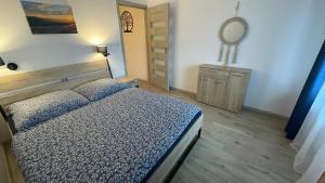 a bedroom with a bed and a mirror on the wall at Dwupoziomowe Apartamenty Leszczyna in Ustroń