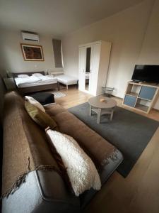a living room with a couch and a table at Deák Houses in Nagykőrös