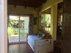 a bedroom with a bed and a sliding glass door at Las Marías qta in Arturo SeguÃ­