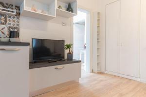 a living room with a flat screen tv on a wall at La Vecchia Sartoria, Caldonazzo Ospitar in Caldonazzo