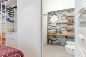 a bathroom with a toilet and a sink at La Vecchia Sartoria, Caldonazzo Ospitar in Caldonazzo +26 photos