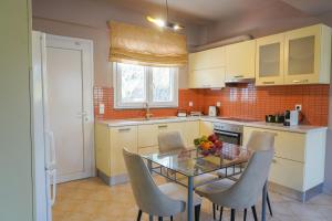 a kitchen with a glass table and chairs in it at ΛΝΛPliON home in Nafplio