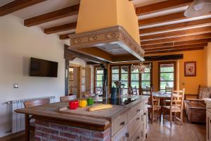 a kitchen with an island in the middle of a room at The Stone House in Bárcena de Pie de Concha