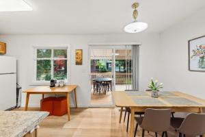a kitchen and dining room with a table and chairs at Parkside Escape Oasis in Bellevue fully fenced in Bellevue