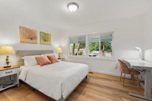 a bedroom with a bed and a desk and a sink at Parkside Escape Oasis in Bellevue fully fenced in Bellevue