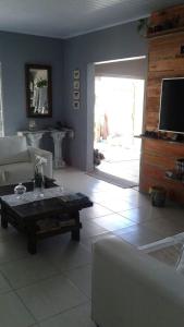 a living room with a couch and a coffee table at Casa verão 2025 in Tramandaí