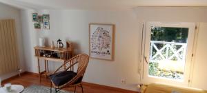 a living room with a chair and a window at Chambre d'hôtes DOLCE FARNIENTE in La Roche-sur-Yon