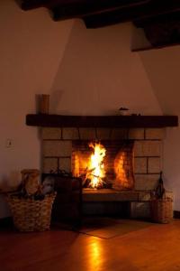 a fireplace in a living room with a fire in it at 4 bedrooms house, 4km from San Vicente beach in La Cotera