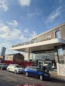 a blue car parked in front of a building at Stylish Digbeth Apartment, Sleeps 12 Opposite Birmingham Coach Station, perfect for large groups contractors in Birmingham