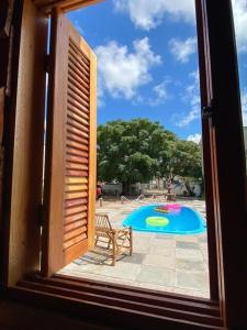 a view of a swimming pool from a window at Pousada Refúgio da Marola in São Lourenço do Sul