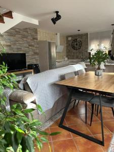 a living room with a couch and a table at Casa el sabinar in Anchuela del Campo +45 photos