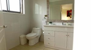 a bathroom with a toilet and a sink and a mirror at Hotel San Fernando in San Fernando