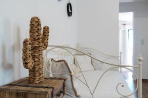 a cactus sculpture on a wooden box next to a bed at Astrio Suites in Livadi