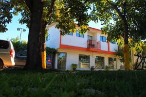 a white house with a tree in front of it at Hotel San Fernando in San Fernando +12 photos