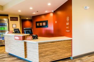 a cashier counter in a restaurant with orange walls at TownePlace Suites by Marriott Evansville Newburgh in Newburgh +57 photos