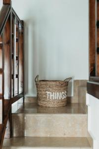 a basket with the words things sits on the stairs at Astrio Suites in Livadi