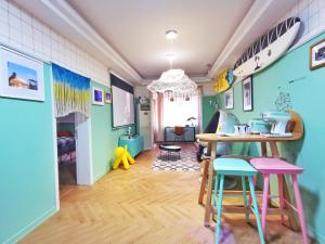 a room with a table and chairs and surfboards on the wall at Chengdu city center Tianfu Square Kuanzhai Alley People's Park subway post-modern design 85 square meters 2 bedrooms 1 living room design B&B HD cinema family suite in Chengdu