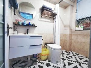 a bathroom with a sink and a toilet at Chengdu city center Tianfu Square Kuanzhai Alley People's Park subway post-modern design 85 square meters 2 bedrooms 1 living room design B&B HD cinema family suite in Chengdu