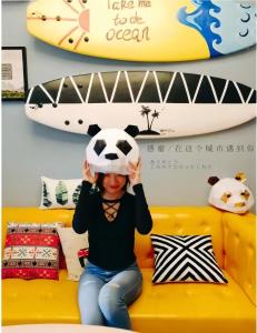 a woman sitting on a yellow couch holding a soccer ball on her head at Chengdu city center Tianfu Square Kuanzhai Alley People's Park subway post-modern design 85 square meters 2 bedrooms 1 living room design B&B HD cinema family suite in Chengdu