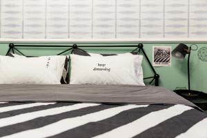 a bedroom with a bed with two pillows at Chengdu city center Tianfu Square Kuanzhai Alley People's Park subway post-modern design 85 square meters 2 bedrooms 1 living room design B&B HD cinema family suite in Chengdu
