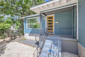 a blue house with a porch and stairs to the door at Authentic Austin Pad with Roof-top Deck Bar in Austin +10 photos